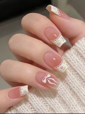 15 pairs of French Tip Nails with White Floral and Bow Accent
